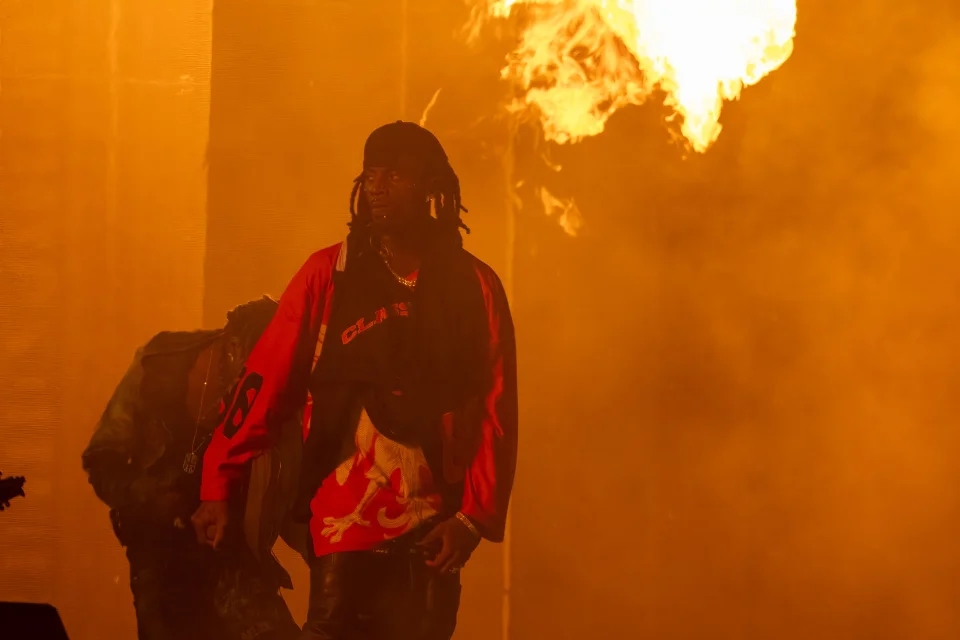 Playboi Carti performing at Clout Festival 2024 amid fire and smoke on stage