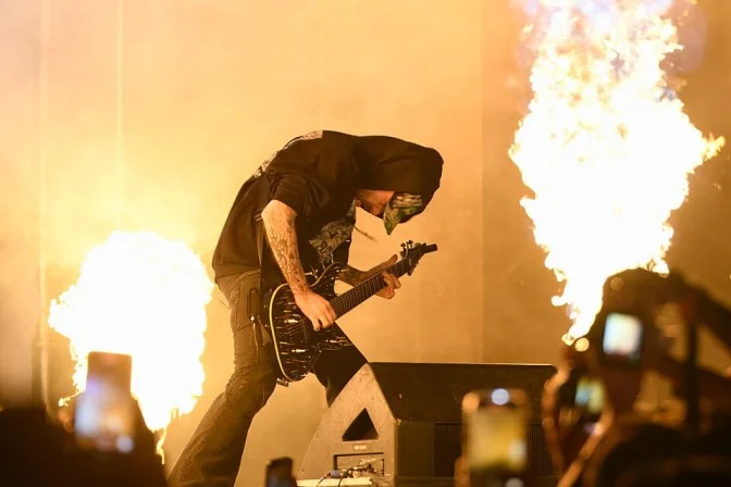 Playboi Carti performing live with guitar and pyrotechnics on stage