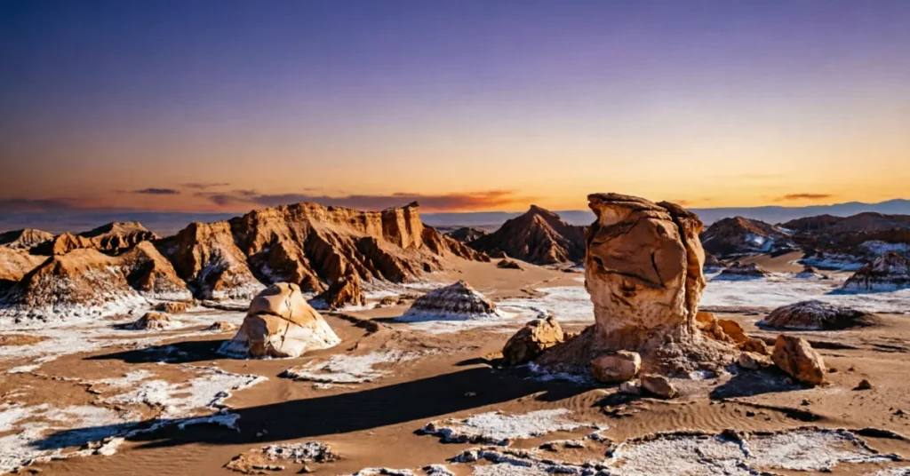 Atacama Desert Valley of the Moon showing dramatic rock formations with salt deposits at sunset, Chile