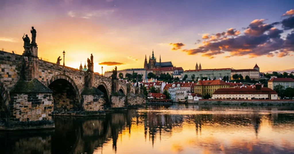 Prague Charles Bridge sunset with castle skyline and golden river reflections