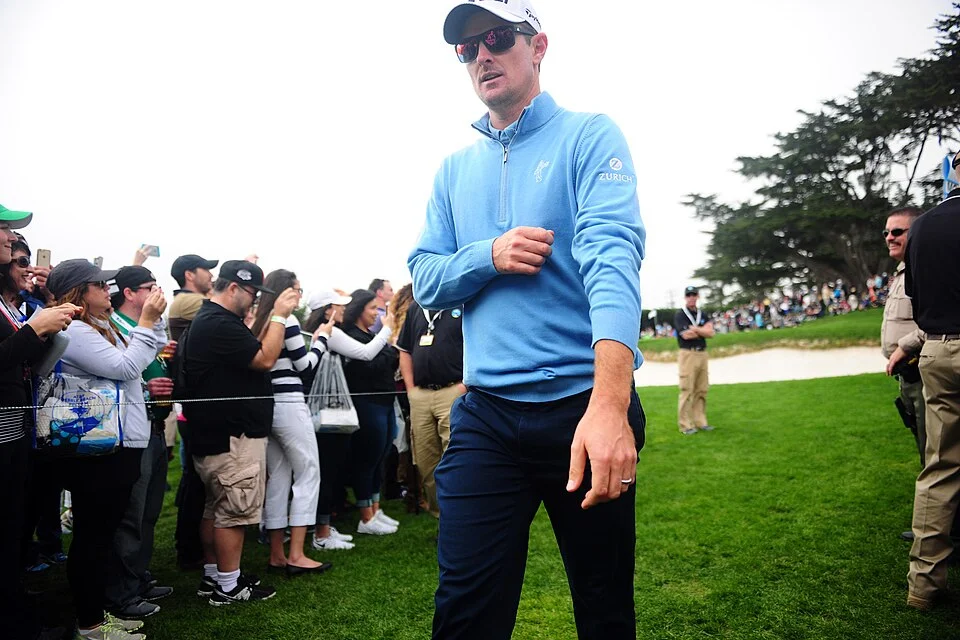 Justin Rose walking the fairway wearing Zurich branding at Pebble Beach — mantlemagazine.com