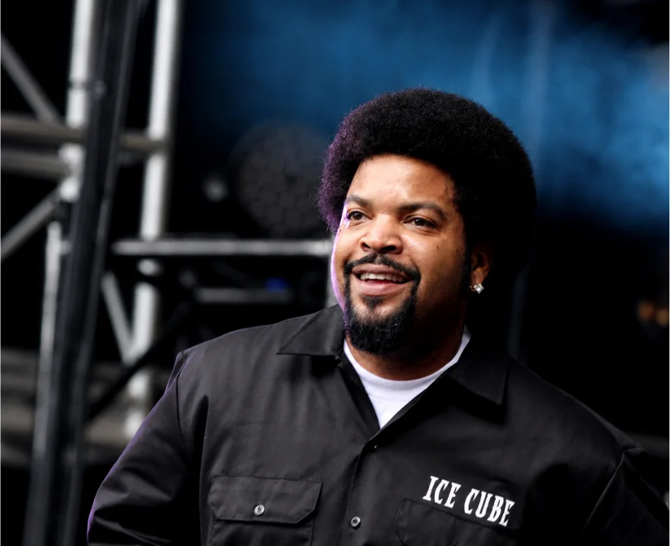 "Ice Cube smiling at public event - The $160-190 million net worth entrepreneur and BIG3 founder photographed courtside at basketball league game in 2026"