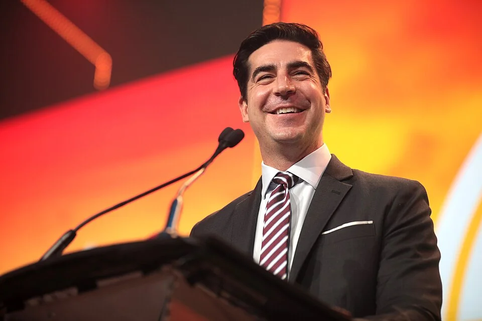 Jesse Watters speaking at a podium in a dark suit