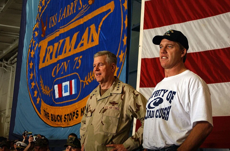 John Elway with Gen. Richard Myers during a 2004 troop visit aboard USS Harry S. Truman — mantlemagazine.com