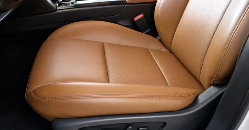 How to fix tear in car seat: a clean tan leather seat after repair showing a blended finish