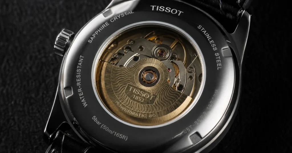 Is Tissot a good brand: a sapphire caseback showing the Powermatic 80 movement with a gold rotor