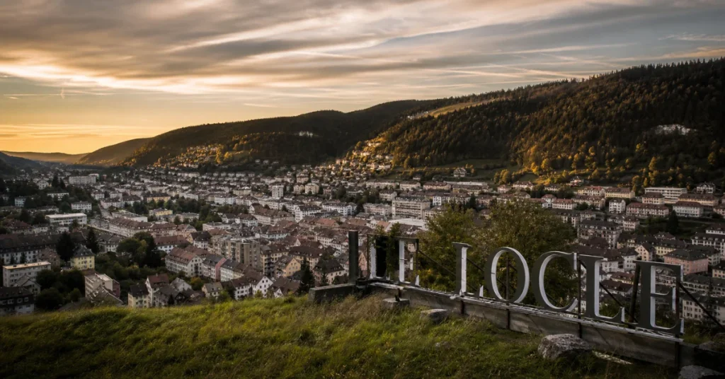 Is Tissot a luxury brand: the watchmaking town of Le Locle in the Swiss Jura Mountains at sunset