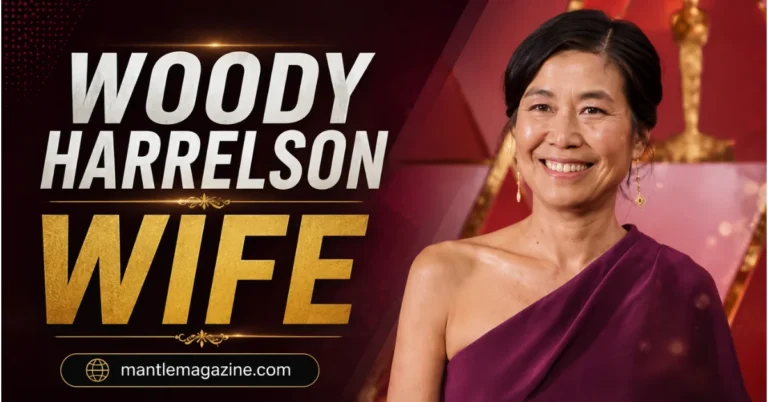 Woody Harrelson's wife Laura Louie smiling in a purple one-shoulder gown on a red-carpet backdrop