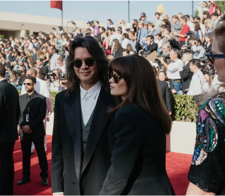 Valerie Bertinelli and Eddie Van Halen walking a red carpet together in matching sunglasses