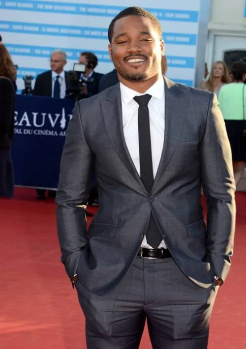 Ryan Coogler on red carpet in gray suit, Sinners director with $15-25 million net worth