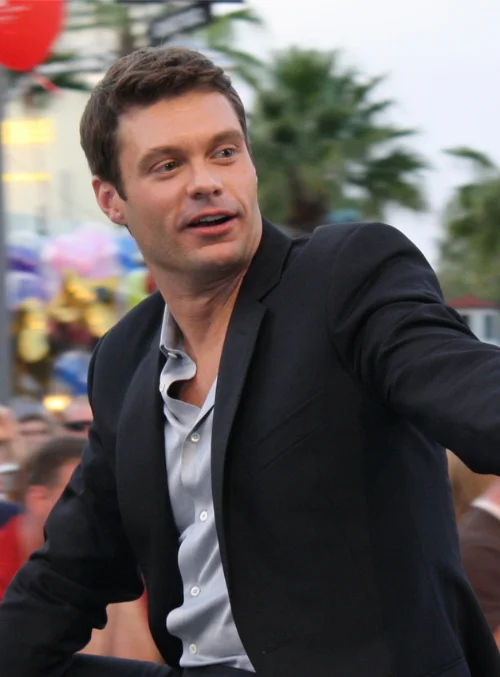 Ryan Seacrest in a black blazer at an outdoor event