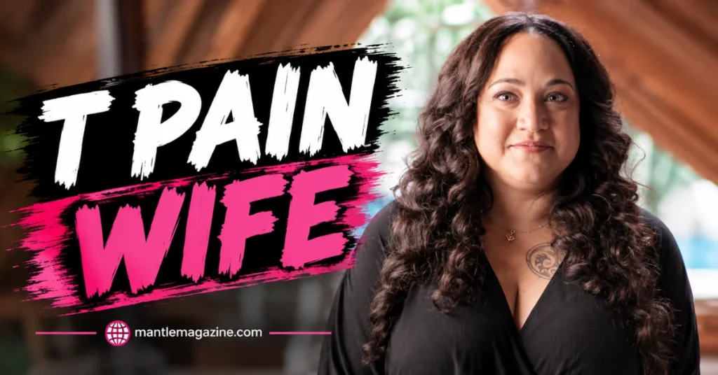 Amber Najm, wife of rapper T-Pain, smiling in a black top with long curly hair and a chest tattoo