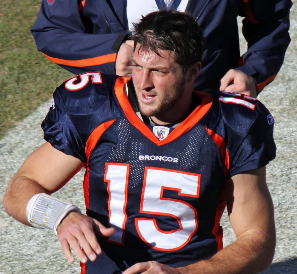 Tim Tebow wearing his number 15 Denver Broncos jersey during his NFL playing career.