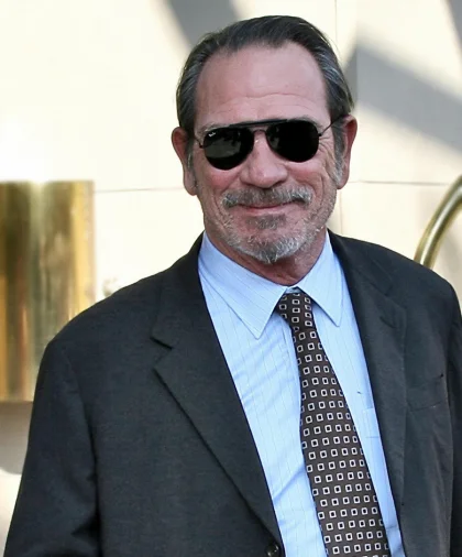Tommy Lee Jones in sunglasses and a gray suit at a public appearance