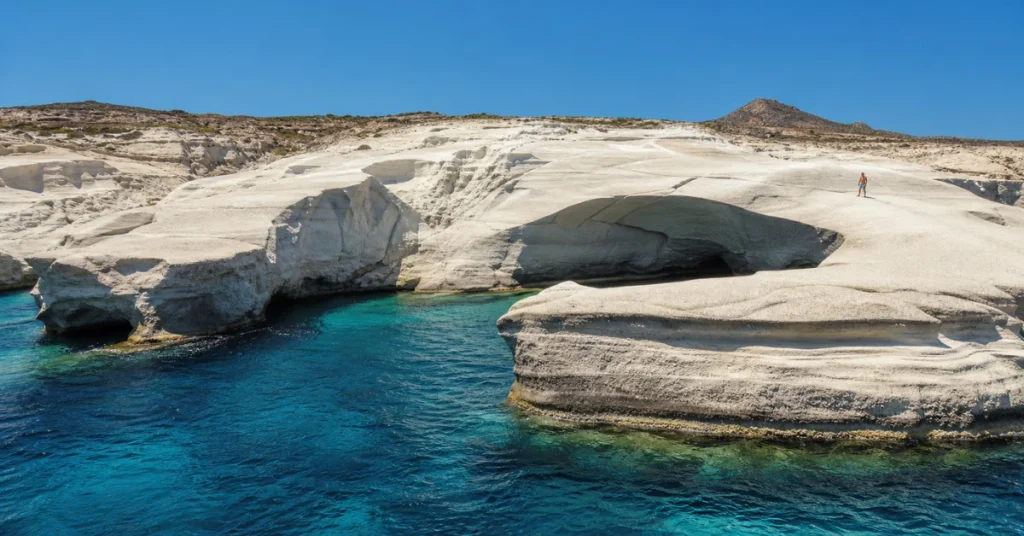 Best islands to visit in Greece: the lunar-white volcanic rock coastline of Sarakiniko on Milos meeting turquoise Aegean water