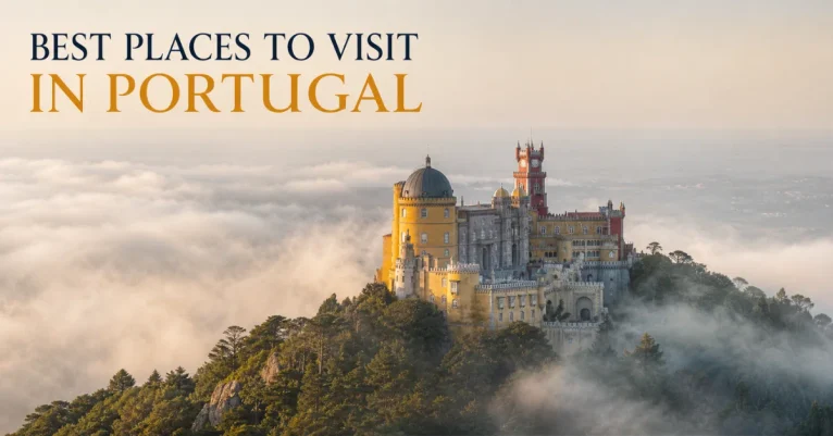 Best places to visit in Portugal: Pena Palace rising above a misty hilltop forest in Sintra with its yellow and red facade in soft light