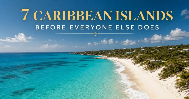 Caribbean islands to visit: an aerial view of a quiet Anguilla-style bay with turquoise water meeting white sand and hillside villas